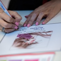 Close-up of a signing session.

