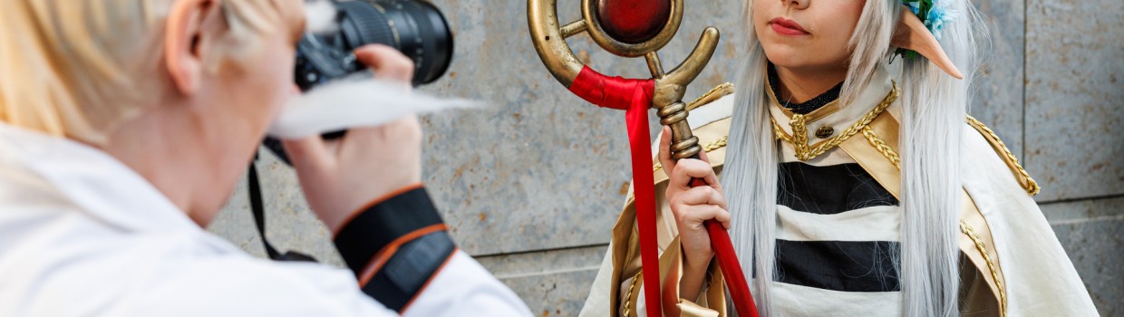 Cosplayer taking a photo of another cosplayer at the Manga Comic Con 2025.
