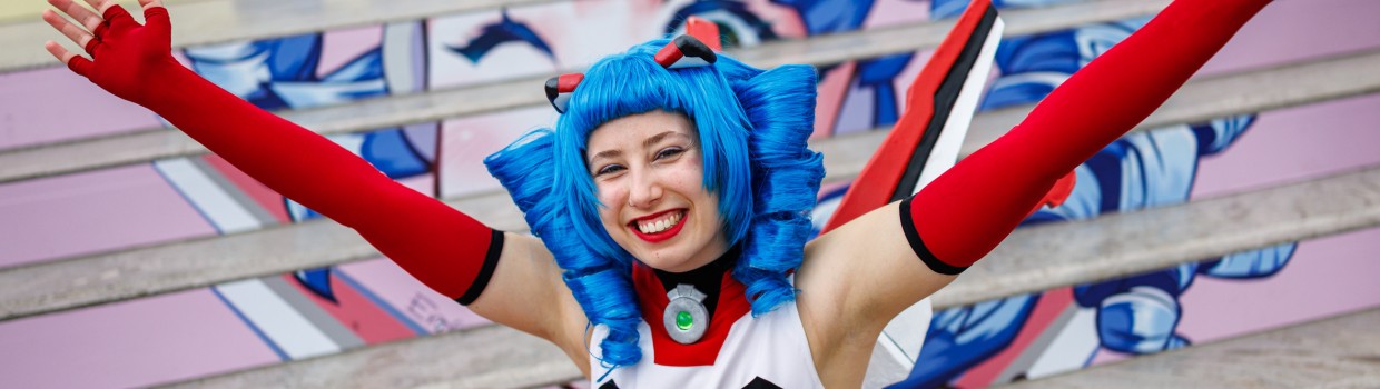 The mascot of Manga Comic Com 2025, Macoco, smiles for the camera. 