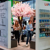 Lappan Publishing Group booth at Manga Comic Con 2025 with comics, books, and cherry blossom trees