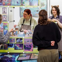 Artist booth with visitors in the New Artist Alley at the Manga Comic Con 2025
